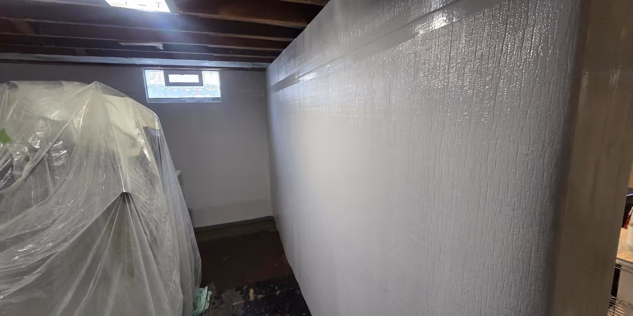 Basement water tank and waterproofed wall